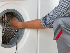 Dryer repair technician diagnosing and servicing a clothes dryer in Syracuse, NY