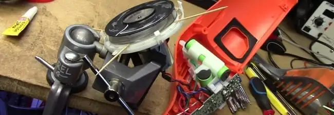 Vacuum cleaner repair parts and tools on a workbench in Syracuse, NY