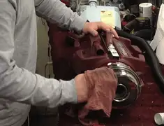 Vacuum repair technician cleaning and servicing a vacuum motor in Syracuse, NY